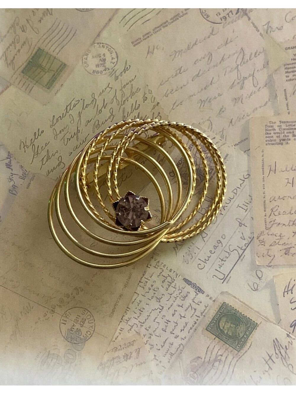 Vintage Gold Tone Swirl Brooch with Purple Gemstone Accent - Elegant Pin
